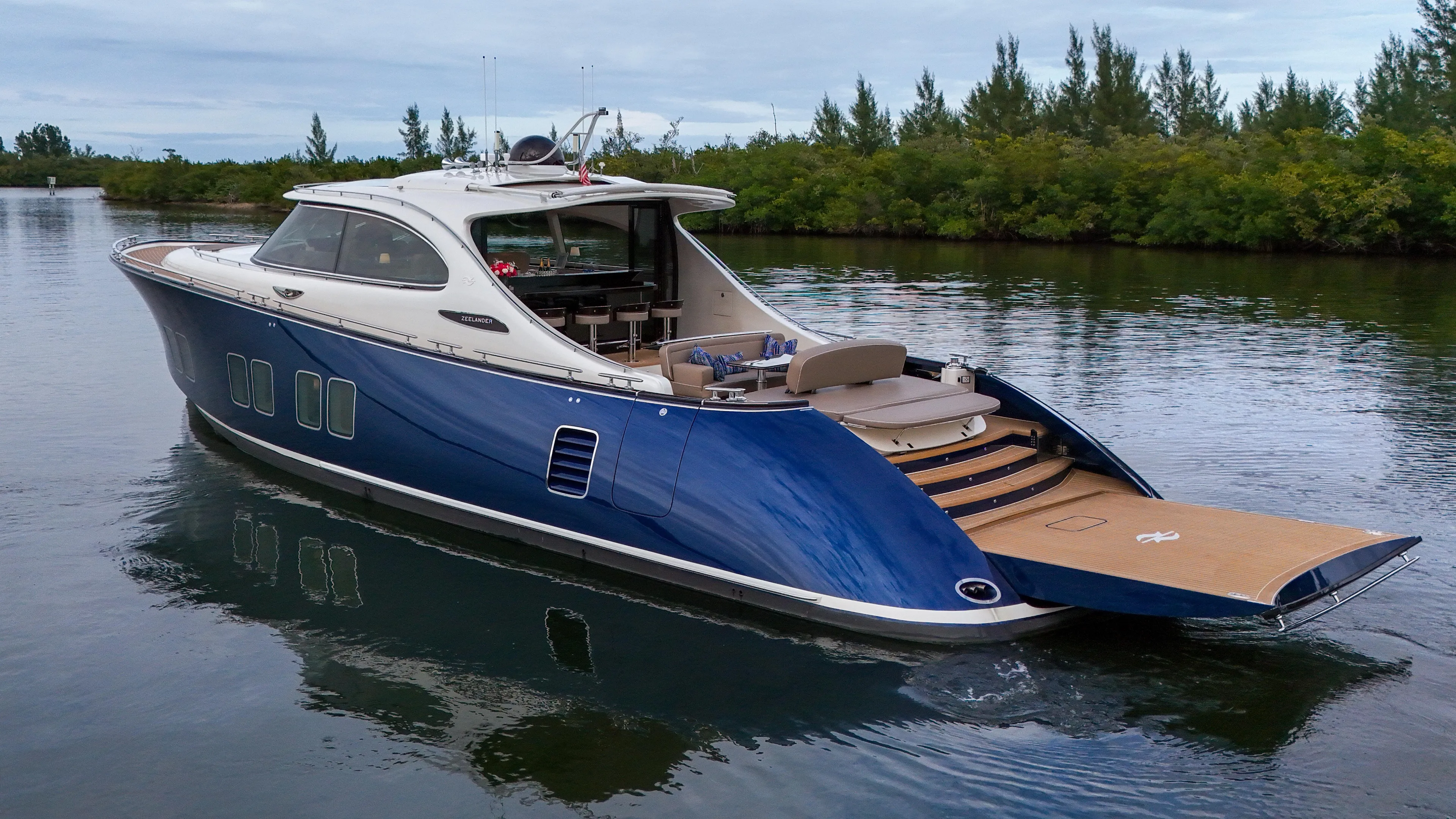 Maddamc2 Yacht Photos Pics 2023 Zeelander 72 luxury yacht cruising on a serene waterway.