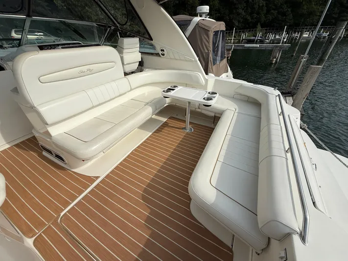 Seascape Yacht Photos Pics 1998 Sea Ray 400 Sundancer yacht with white seating and wooden deck, docked by the water.