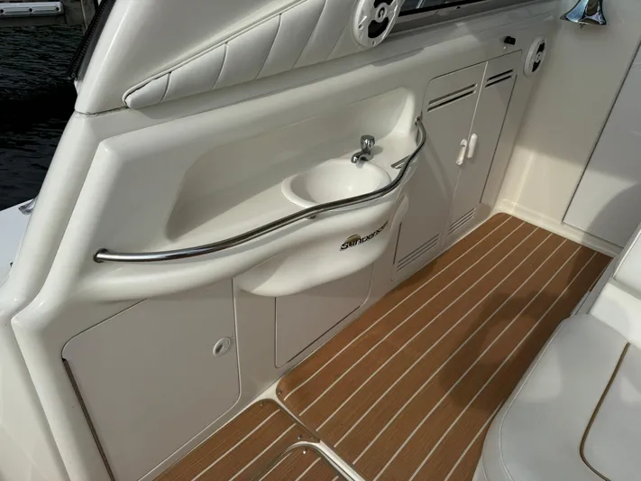 Seascape Yacht Photos Pics 1998 Sea Ray 400 Sundancer interior with sink and storage cabinets.
