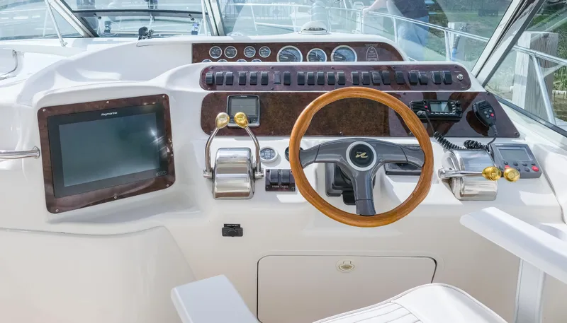 Seascape Yacht Photos Pics 1998 Sea Ray 400 Sundancer helm with wooden steering wheel and modern navigation controls.