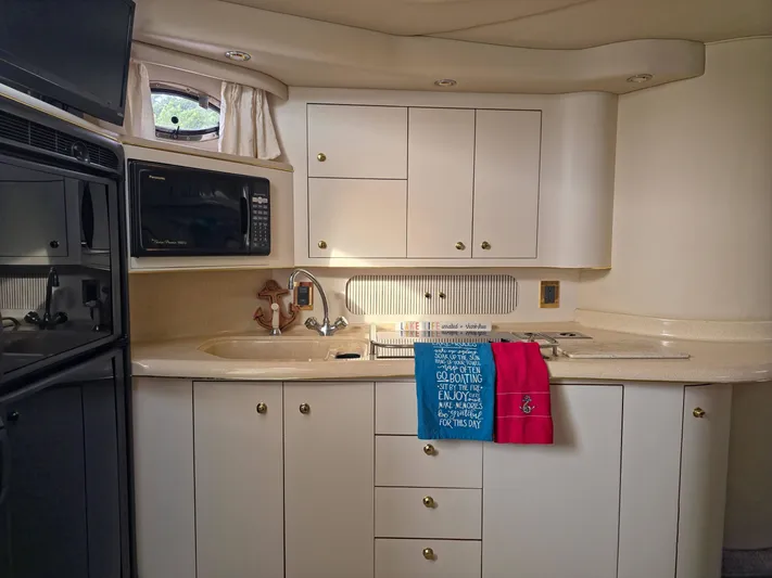 Seascape Yacht Photos Pics Interior of 1998 Sea Ray 400 Sundancer yacht kitchen with microwave and sink.