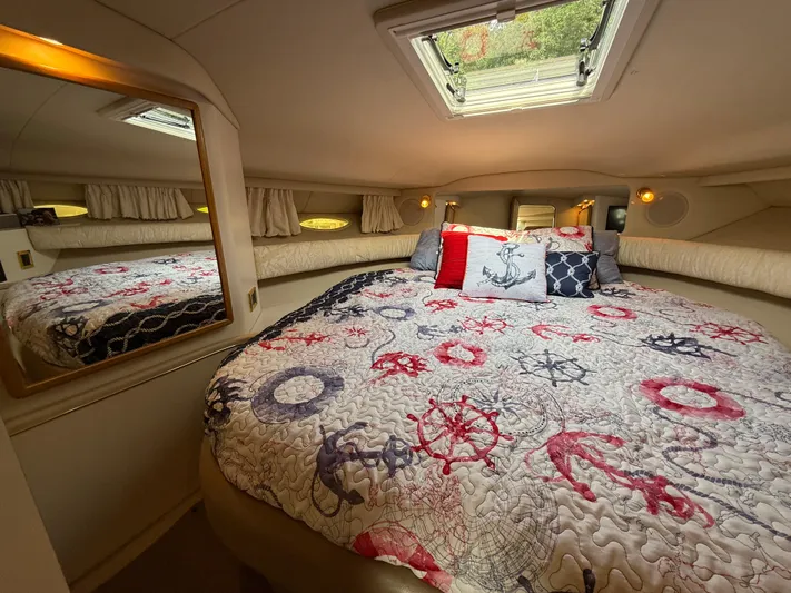 Seascape Yacht Photos Pics Cozy cabin interior of 1998 Sea Ray 400 Sundancer with nautical-themed bedding.