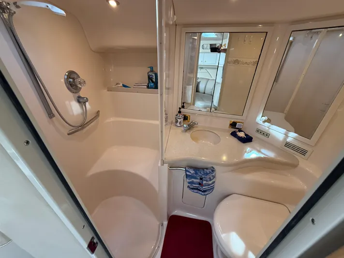 Seascape Yacht Photos Pics Bathroom interior of 1998 Sea Ray 400 Sundancer yacht, featuring shower and vanity.