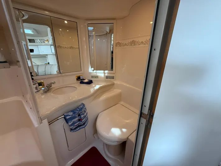 Seascape Yacht Photos Pics Bathroom interior of 1998 Sea Ray 400 Sundancer yacht, featuring sink, mirror, and toilet.