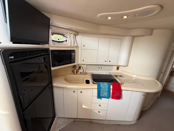 Seascape Yacht Photos Pics Interior of 1998 Sea Ray 400 Sundancer yacht kitchen with modern appliances and cabinetry.