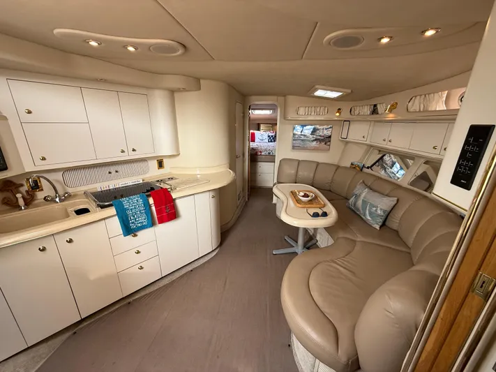 Seascape Yacht Photos Pics Luxurious interior of 1998 Sea Ray 400 Sundancer yacht with kitchen and seating area.