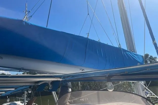 Three Seas Yacht Photos Pics 2002 Fountaine Pajot Belize 43 sailboat with blue sail cover under clear sky.