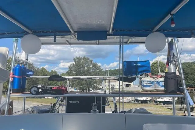 Three Seas Yacht Photos Pics 2002 Fountaine Pajot Belize 43 catamaran deck with equipment under blue canopy.