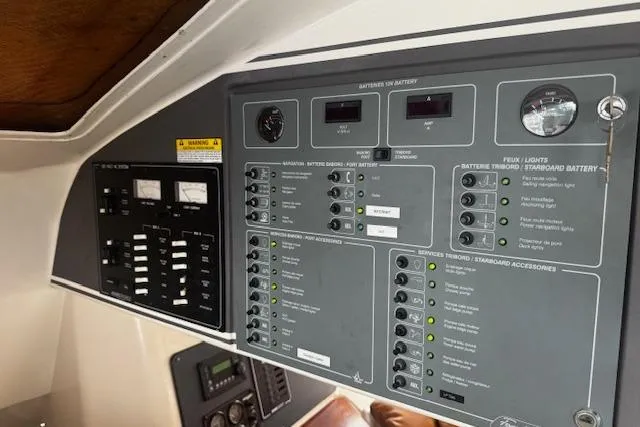 Three Seas Yacht Photos Pics Control panel of a 2002 Fountaine Pajot Belize 43 catamaran, featuring various switches and gauges.