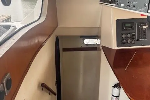 Three Seas Yacht Photos Pics Interior view of 2002 Fountaine Pajot Belize 43 yacht, featuring control panel and wooden staircase.