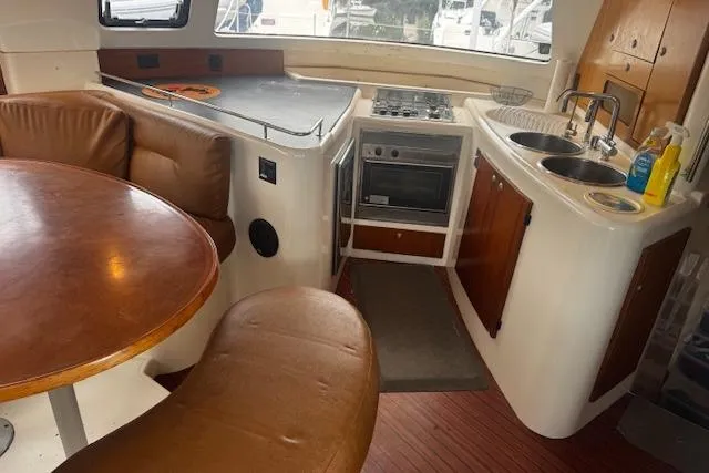 Three Seas Yacht Photos Pics Interior of 2002 Fountaine Pajot Belize 43 catamaran with kitchen and dining area.