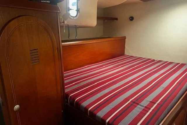 Three Seas Yacht Photos Pics Cozy cabin interior of 2002 Fountaine Pajot Belize 43 with striped bedding.