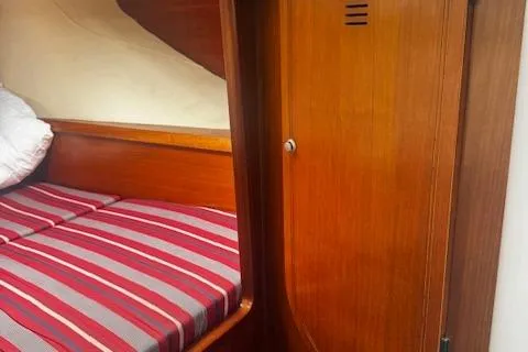 Three Seas Yacht Photos Pics Cozy cabin interior of 2002 Fountaine Pajot Belize 43 with striped bedding.