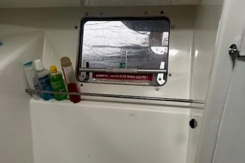 Three Seas Yacht Photos Pics Interior of 2002 Fountaine Pajot Belize 43 with toiletries and a small window.