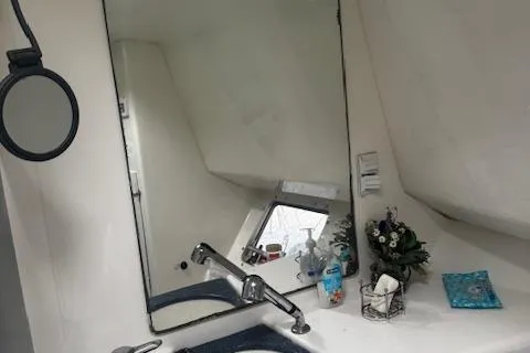 Three Seas Yacht Photos Pics Bathroom interior of 2002 Fountaine Pajot Belize 43 catamaran with mirror and sink.