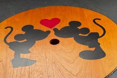 Three Seas Yacht Photos Pics Silhouettes of cartoon mice with a red heart on a wooden surface.