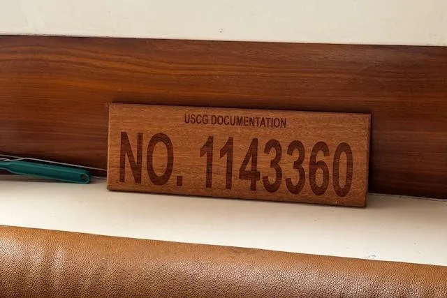 Three Seas Yacht Photos Pics USCG documentation plaque with number 1143360 on Fountaine Pajot Belize 43, 2002 model.