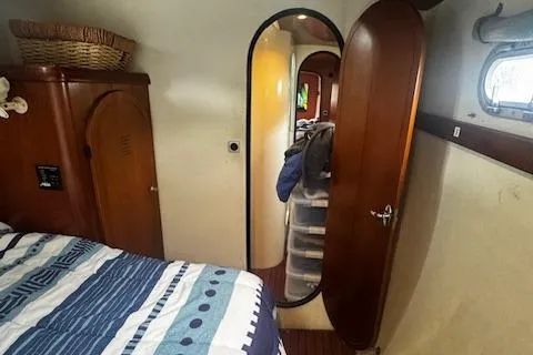 Three Seas Yacht Photos Pics Interior of 2002 Fountaine Pajot Belize 43 catamaran cabin with bed and wooden furnishings.