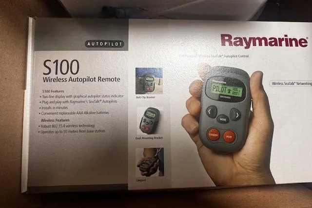 Three Seas Yacht Photos Pics Raymarine S100 Wireless Autopilot Remote packaging with remote control in hand.