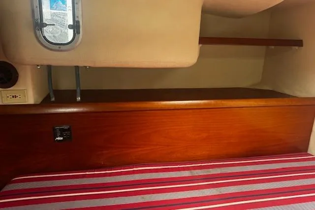 Three Seas Yacht Photos Pics Interior cabin of 2002 Fountaine Pajot Belize 43 with striped bedding and wooden accents.