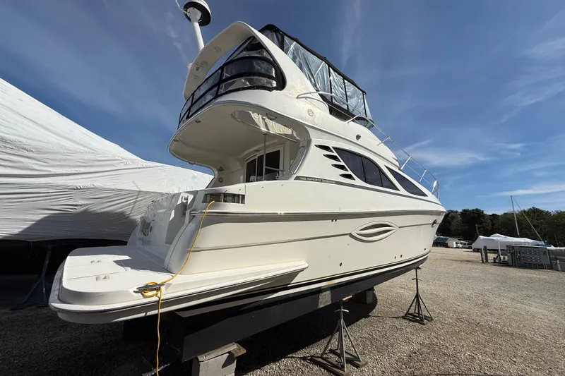  Yacht Photos Pics 2005 Silverton 38 Sport Bridge yacht on dry dock under clear blue sky.