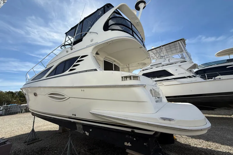  Yacht Photos Pics 2005 Silverton 38 Sport Bridge yacht on display, showcasing sleek design and spacious deck.