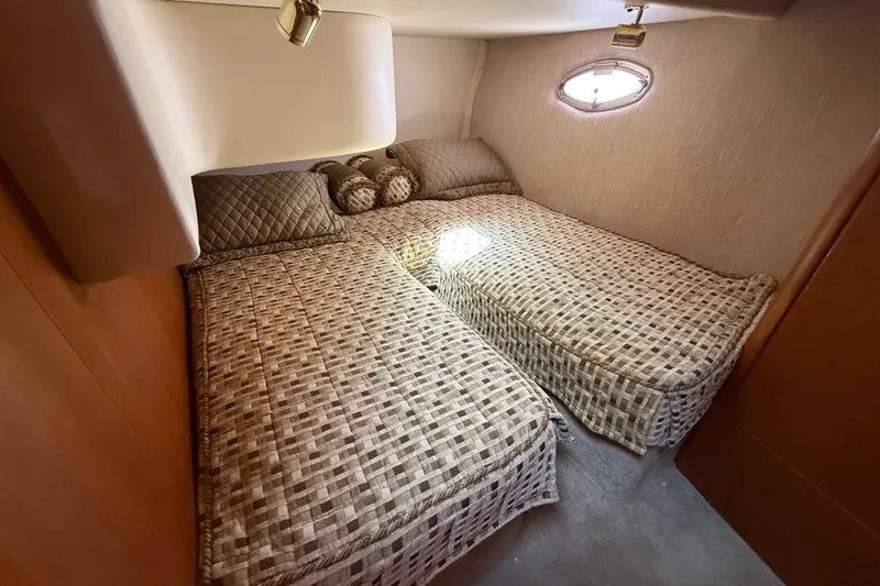  Yacht Photos Pics 2005 Silverton 38 Sport Bridge cabin with twin beds and patterned bedding.