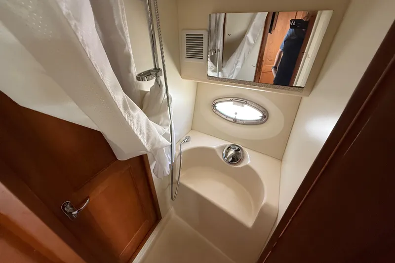  Yacht Photos Pics Compact bathroom in 2005 Silverton 38 Sport Bridge yacht with shower and mirror.