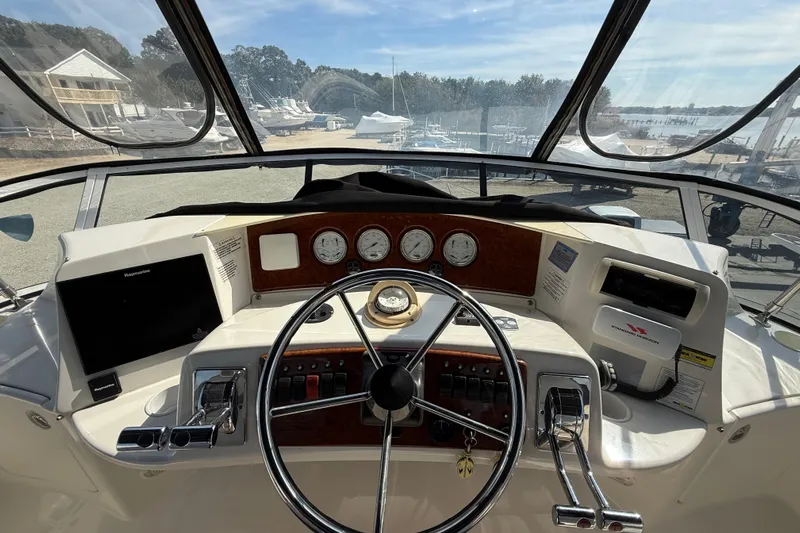  Yacht Photos Pics 2005 Silverton 38 Sport Bridge helm with steering wheel, gauges, and navigation equipment.