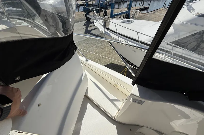  Yacht Photos Pics 2005 Silverton 38 Sport Bridge yacht docked, featuring sleek design and spacious deck area.