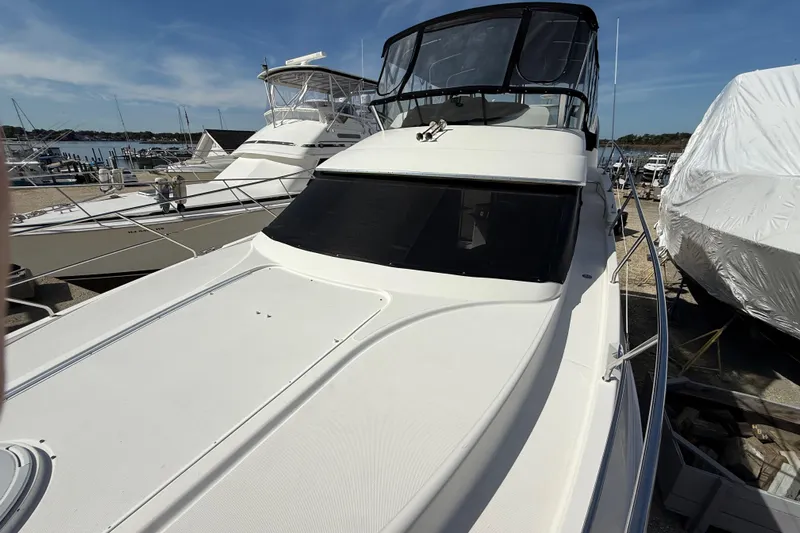  Yacht Photos Pics 2005 Silverton 38 Sport Bridge yacht docked at a marina under clear skies.