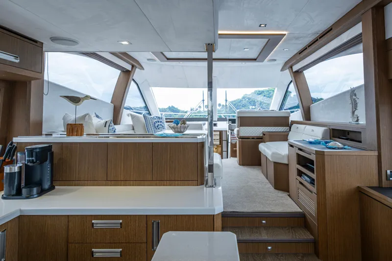 Sunshine Yacht Photos Pics Luxurious interior of 2020 Galeon 550 Fly yacht with modern wood finishes and seating.