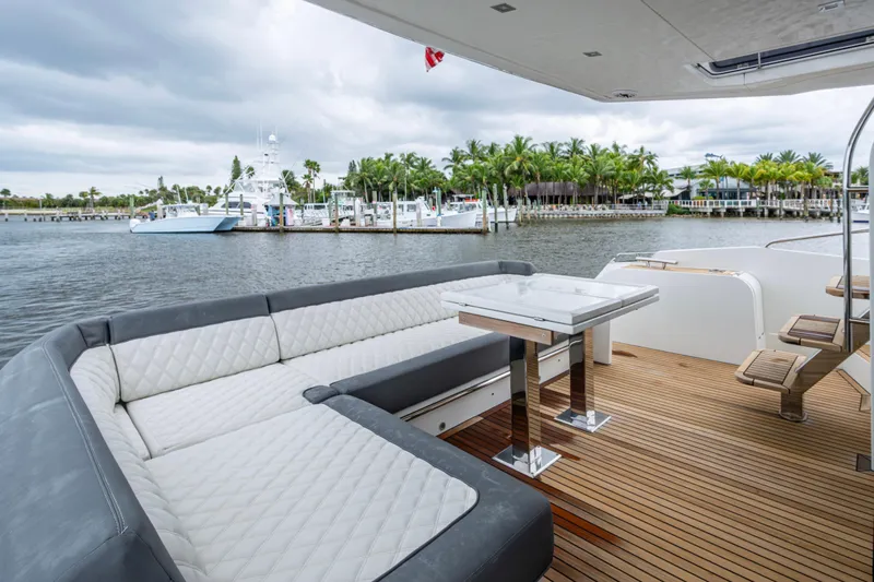Sunshine Yacht Photos Pics Luxurious 2020 Galeon 550 Fly yacht deck with elegant seating and scenic waterfront view.