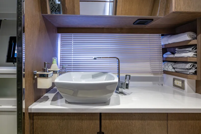 Sunshine Yacht Photos Pics Luxury bathroom interior on 2020 Galeon 550 Fly yacht, featuring modern sink and wooden cabinetry.