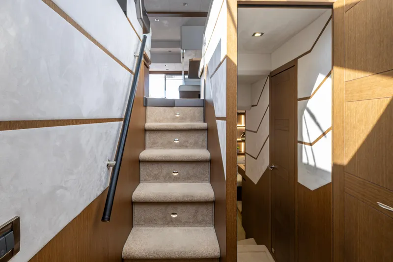 Sunshine Yacht Photos Pics Staircase interior of 2020 Galeon 550 Fly yacht, featuring modern design and wood accents.
