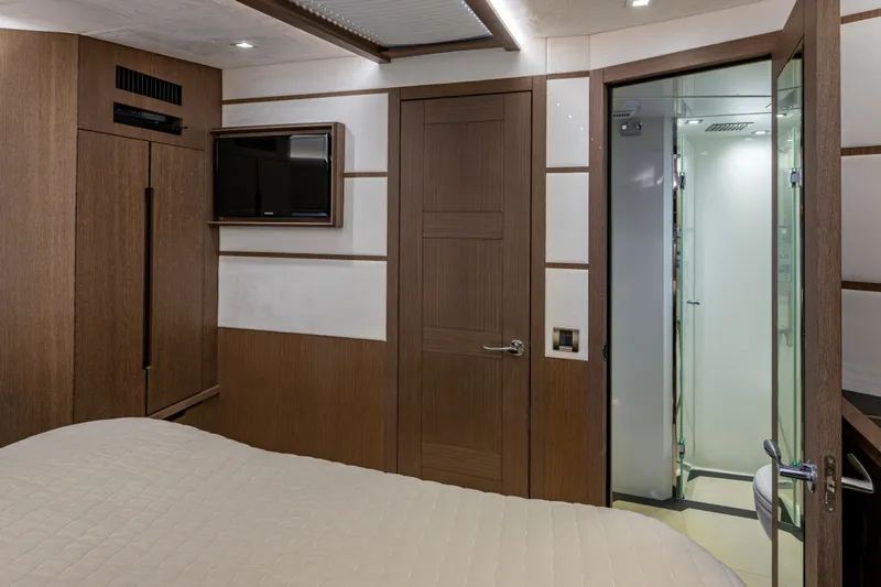 Sunshine Yacht Photos Pics Interior of 2020 Galeon 550 Fly yacht cabin with modern wood paneling and ensuite bathroom.