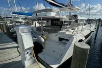 2020 Leopard 50 catamaran docked at marina under blue sky.