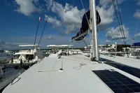 2020 Leopard 50 catamaran deck with solar panels, docked under a clear blue sky.