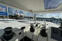 Leopard 50 catamaran deck view, showcasing winches and marina background, 2020 model.
