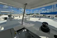 Leopard 50 yacht deck, 2020 model, featuring spacious seating and winch under a clear blue sky.
