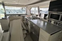 Modern kitchen interior of 2020 Leopard 50 yacht with sleek appliances and ample seating.