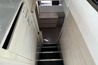 Interior of a 2020 Leopard 50 yacht, featuring modern stairs and sleek cabinetry.