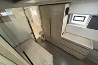 Modern interior of 2020 Leopard 50 yacht with wood finish and ample storage.