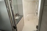 Modern bathroom in 2020 Leopard 50 yacht with shower, sink, and toilet.