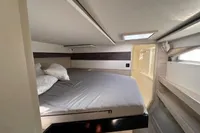 Cozy bedroom in 2020 Leopard 50 yacht with skylight and modern design.