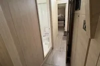 Modern interior of 2020 Leopard 50 yacht with sleek wood paneling and compact bathroom.