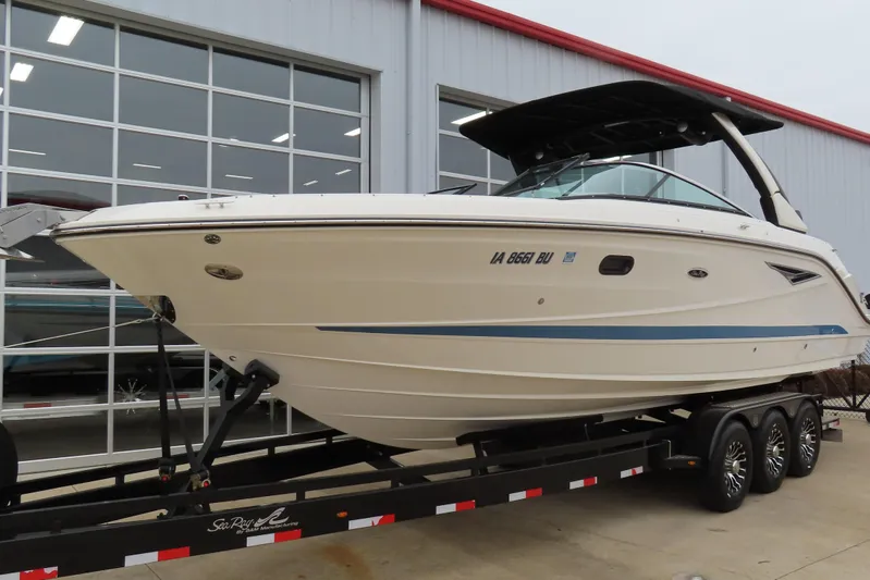  Yacht Photos Pics 2021 Sea Ray 310 SLX boat on trailer outside a modern building.