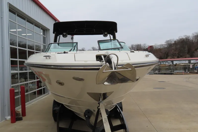  Yacht Photos Pics 2021 Sea Ray 310 SLX boat displayed outdoors near a showroom.