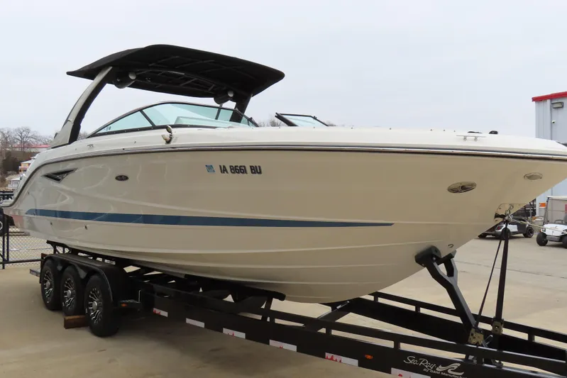  Yacht Photos Pics 2021 Sea Ray 310 SLX boat on trailer, side view, in a marina setting.