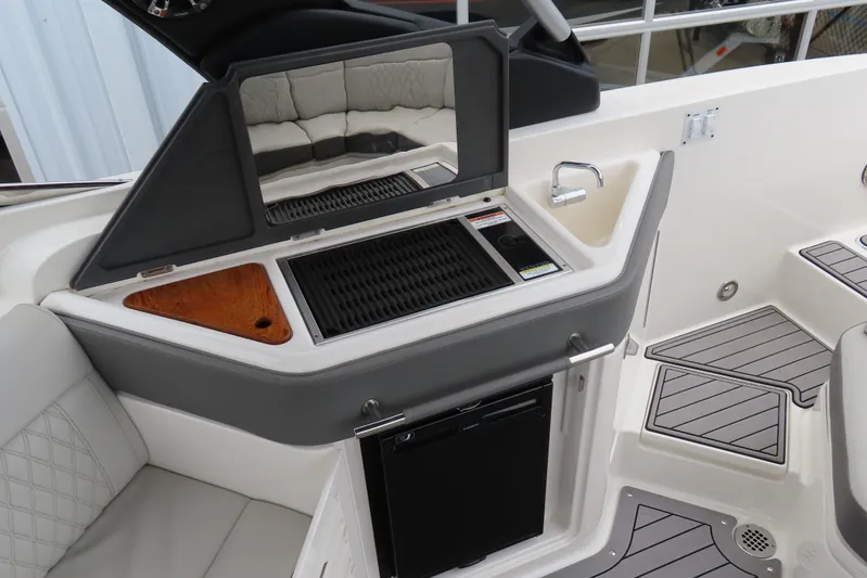  Yacht Photos Pics 2021 Sea Ray 310 SLX boat interior with kitchenette, grill, and seating area.